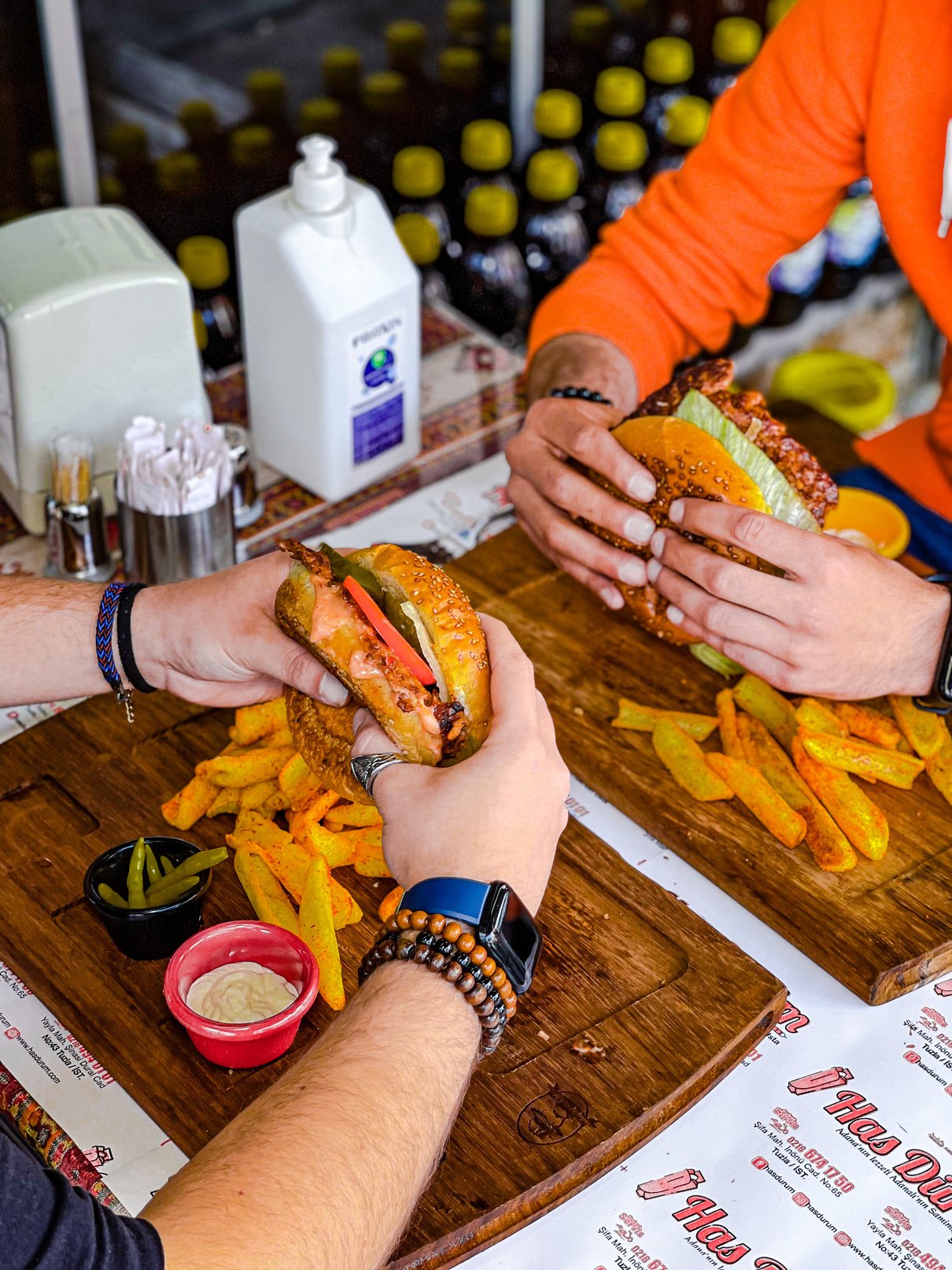 Close-up of People Eating Burgers in a Restaurant 